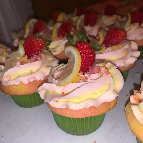 Lemon-berry and specialty cupcakes topped with fresh strawberries