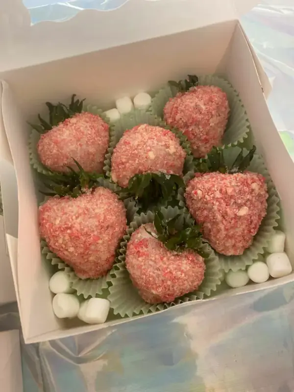 White chocolate strawberries coated in pink strawberry crunch