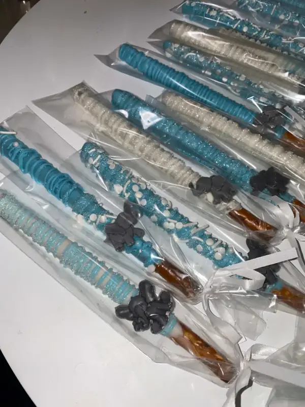 Blue chocolate dipped pretzel rods with sprinkles